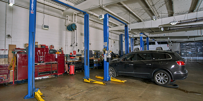Vehicle by automotive lifts in a repair shop