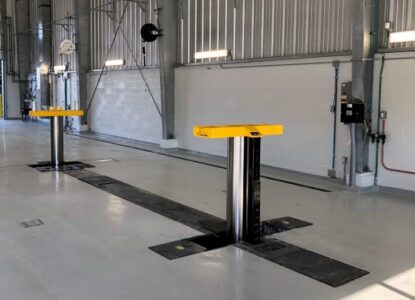 MOD235 in-ground lift installed in a garage floor extended without vehicle